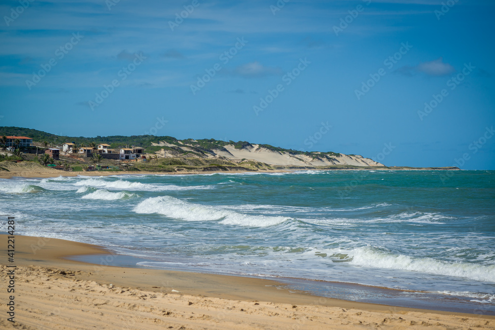 Sea with waves and dunes at Praia do Sagi, Baia Formosa, near Natal, Rio Grande do Norte State, Brazil on January 26, 2021.