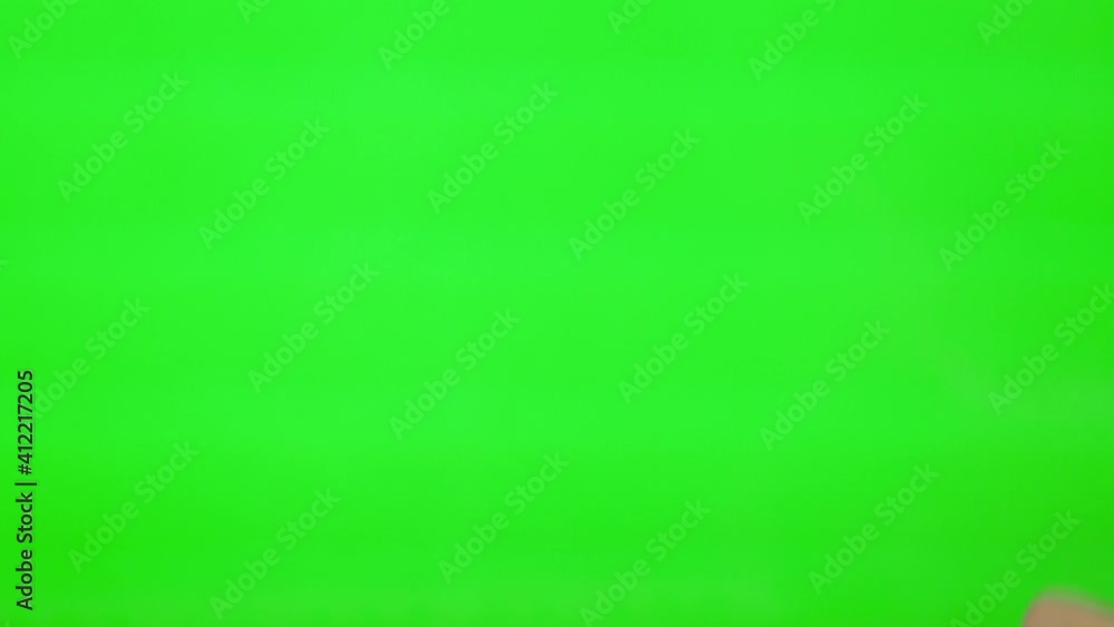 The Hand Flips Slides Touches Drags From Left To Right on the Green Screen, Green Background, Alpha Channel, Mock up, Chroma Key. Surfing the Internet. The Hand Flips Slides Touches Drags From Left To Right on the Green Screen, Green Background, Alpha Channel, Mock up, Chroma Key. Surfing the Internet.