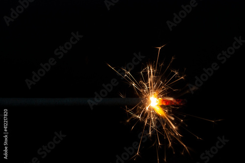 Wallpaper Mural Horizontal conceptual close-up photography with a burning single spark and bright hot yellow spark flying all directions on the black background Torontodigital.ca