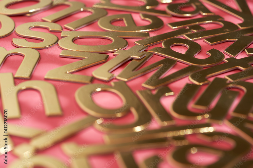 Fototapeta premium gold colored alphabets on the red background