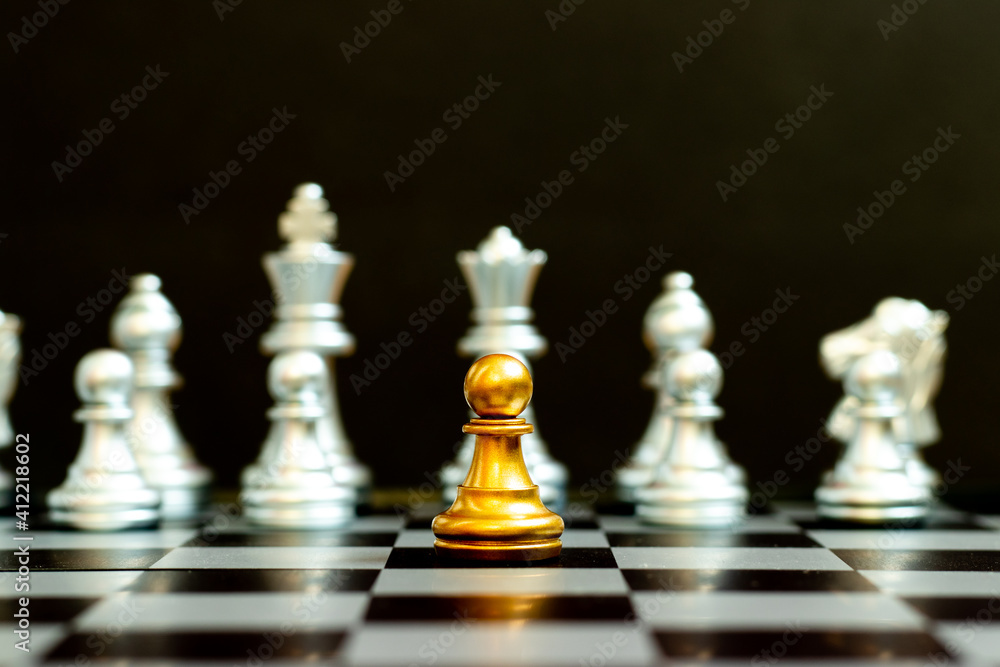 Gold pawn in chess game face with the another silver team on black background (Concept for company strategy, business victory or decision) Gold pawn in chess game face with the another silver team on black background (Concept for company strategy, business victory or decision)
