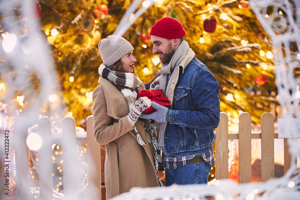 Magic moments of loving couple at Christmas outdoors