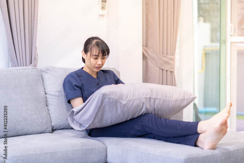 Young asian woman use smart mobile phone on sofa in living room interior Young asian woman use smart mobile phone on sofa in living room interior