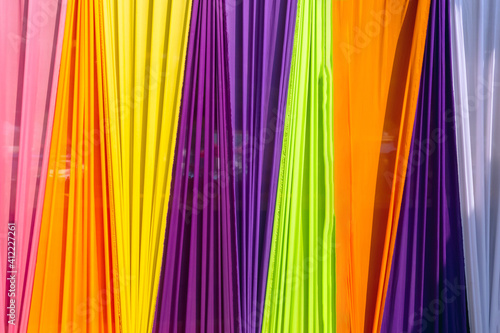 Beautiful multi-colored curtains decorated as a backdrop for the Buddhist ceremonies in Southeast Asia. Fabric colour and texture swatches. Background of colorful curtains hangs seamlessly together.