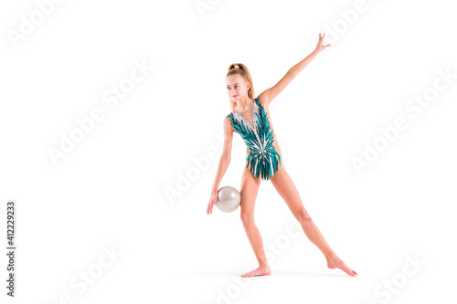 gymnast girl in an emerald swimsuit performs an exercise with a ball isolated on white background