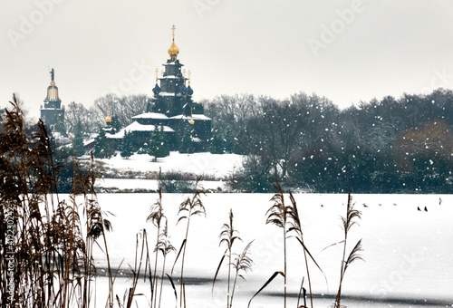 View over the frozen castle lake of Gifhorn, Germany, with the golden towers of the cultural centre in the background. photo