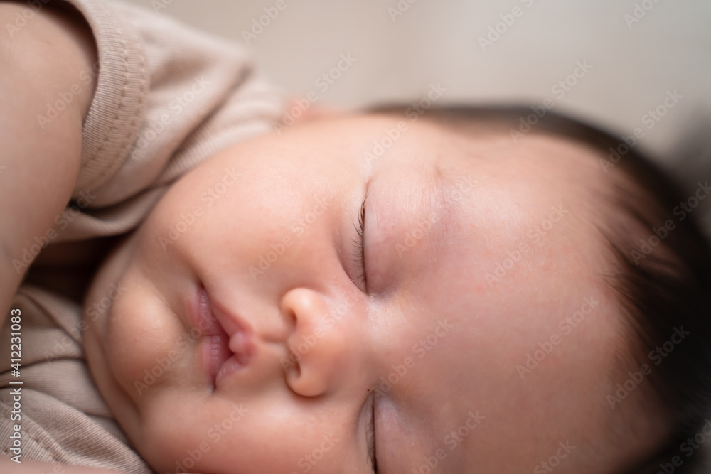 close up asian baby infant face closing eyes sleeping on bed. chubby cheek. close up asian baby infant face closing eyes sleeping on bed. chubby cheek.