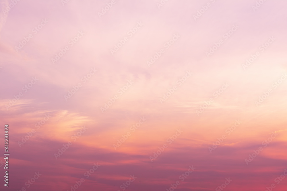 A view of the sky at sunset in vibrant orange pinks and violet colors.
