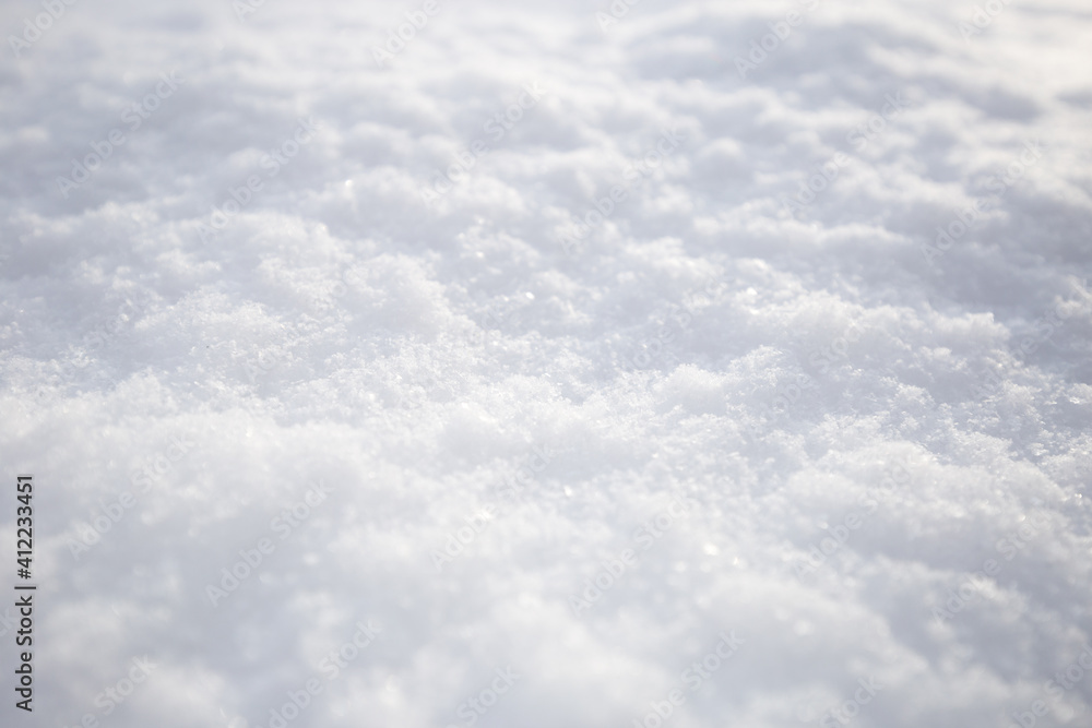 Snow texture. Top view of the white snow. Background with copy space. Winter time