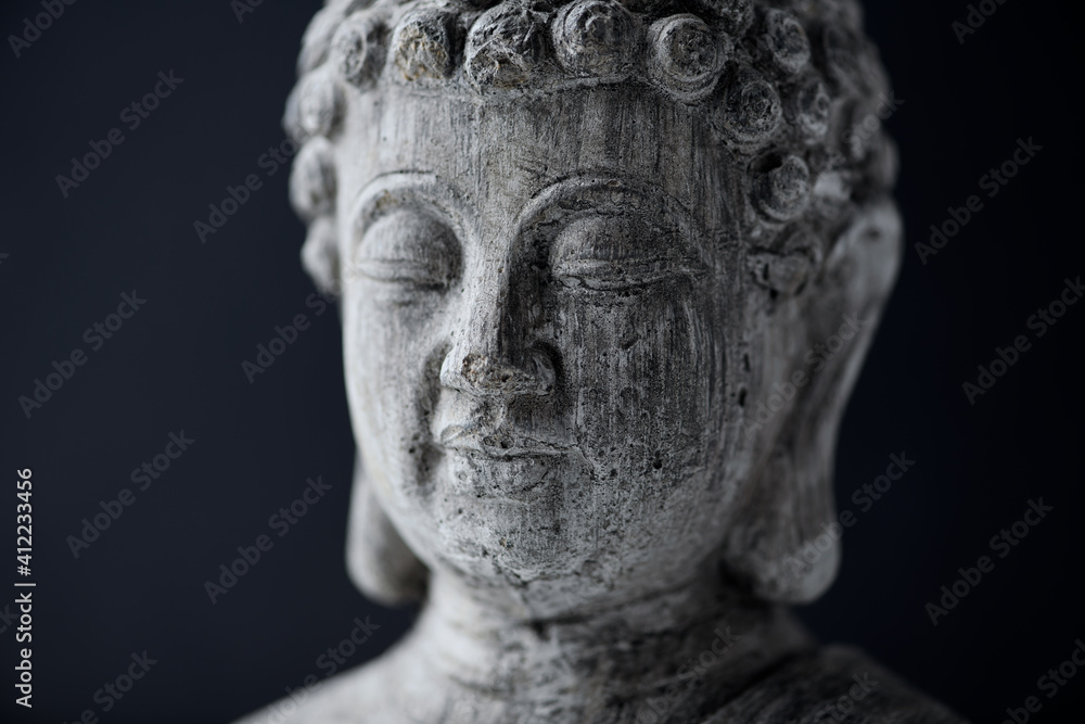 Meditating Buddha Statue on dark background. Close up. Meditating Buddha Statue on dark background. Close up.