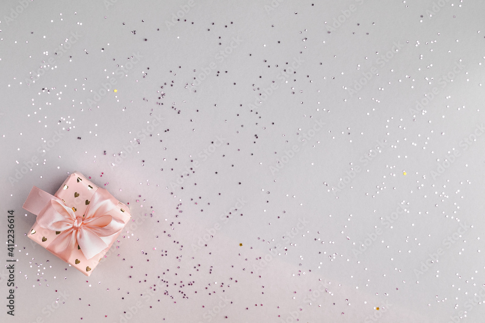Festive pink box with a gift on a gray background. Top view, flat lay. Copy space. Birthday, mothers, valentines, women, wedding day concept. Festive pink box with a gift on a gray background. Top view, flat lay. Copy space. Birthday, mothers, valentines, women, wedding day concept.