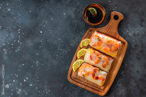 Spring rolls with funchose and shrimps in rice paper top view, photo with copyspace for text