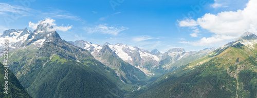 Mountain panorama .Panorama of the mountain range and valley below the blue sky to the horizon photo