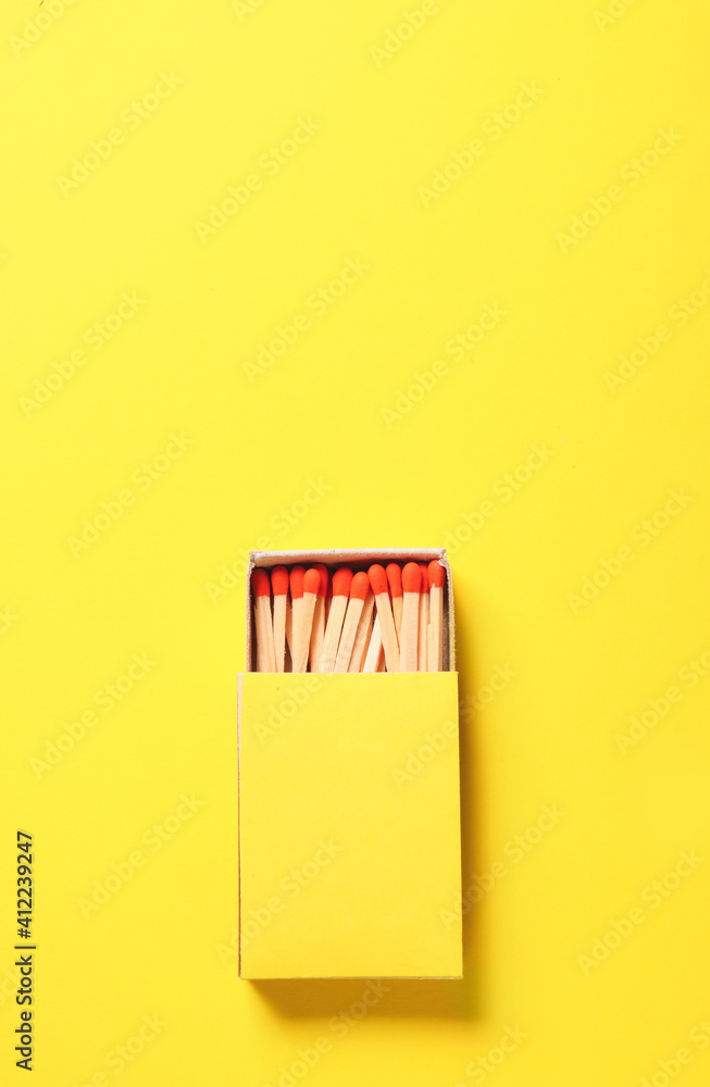 Box with matches on color background