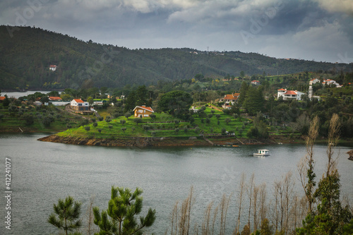 Landscape view of Castelo de Bode waterdam in Portugal. Houses on the riverside of Zezere river