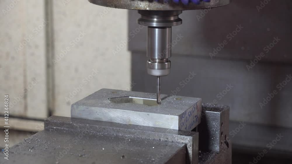 The CNC milling machine cutting the mold and die parts by solid end-mill tool. The hi-precision mold and die manufacturing concept by machining center. The CNC milling machine cutting the mold and die parts by solid end-mill tool. The hi-precision mold and die manufacturing concept by machining center.