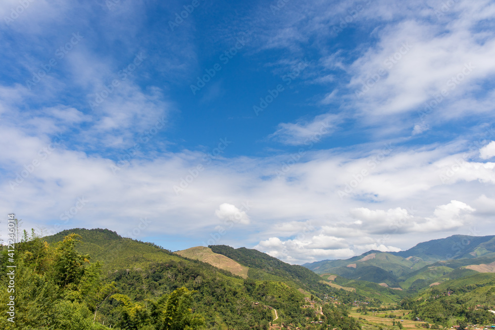 landscape of mountain forest at morning time with blue sky and white cloud.