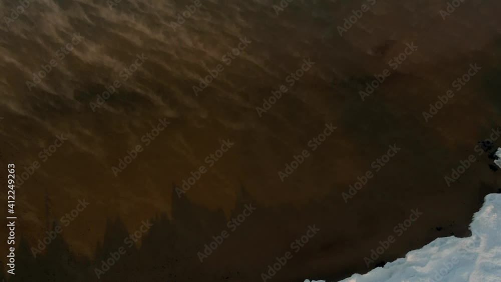 Warm water evaporates from a surface of warm calm sea in cold winter day creating fog Warm water evaporates from a surface of warm calm sea in cold winter day creating fog