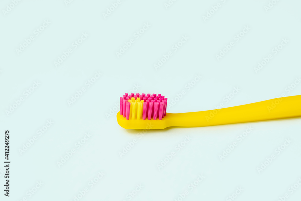 Yellow creative toothbrush on blue background Yellow creative toothbrush on blue background