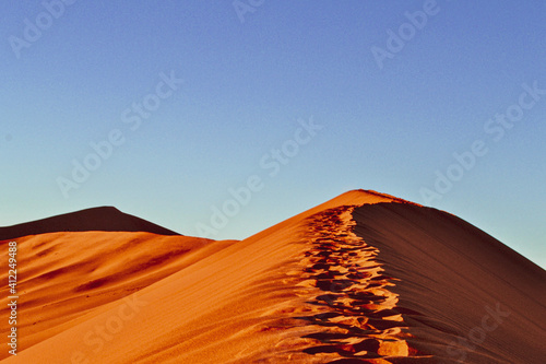 Footprints atop Namibian desert dunes