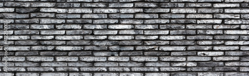 Obraz na płótnie Gray grunge brick wall background. Banner. Wide wall texture of rough brickwork for design. w salonie