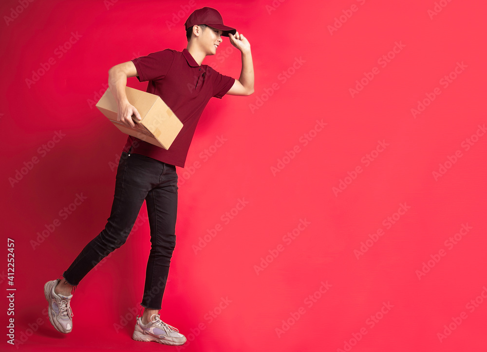 Portrait of a male delivery man holding a cargo box, background Portrait of a male delivery man holding a cargo box, background