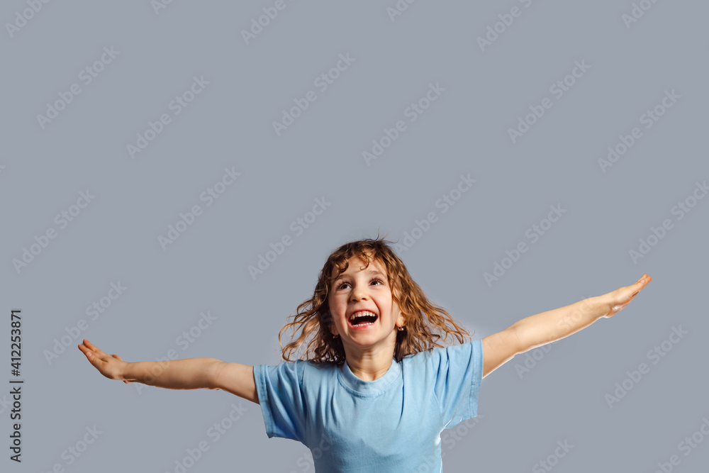 little girl jumps on a gray background little girl jumps on a gray background