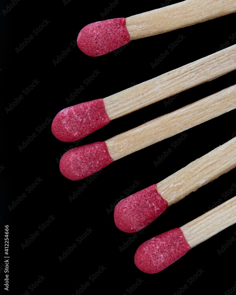 macro of five matches isolated on a black background macro of five matches isolated on a black background