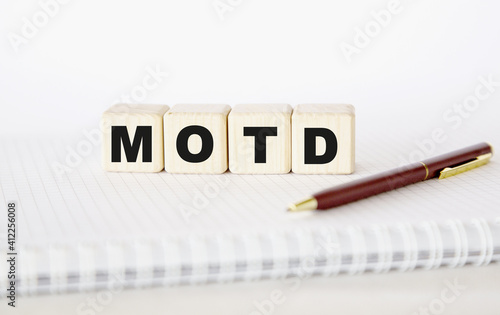 motd written word. cubes, notepad and pen.. You can use in business, marketing and other concepts. Messege of the day. photo