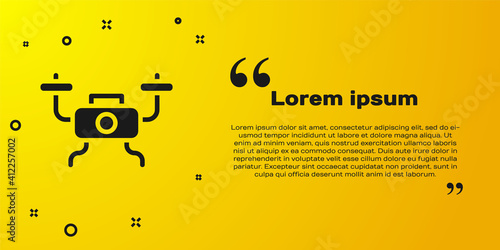 Black Drone flying icon isolated on yellow background. Quadrocopter with video and photo camera symbol. Vector.