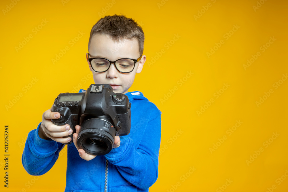The child learns the profession of a photographer in the studio from his father The child learns the profession of a photographer in the studio from his father