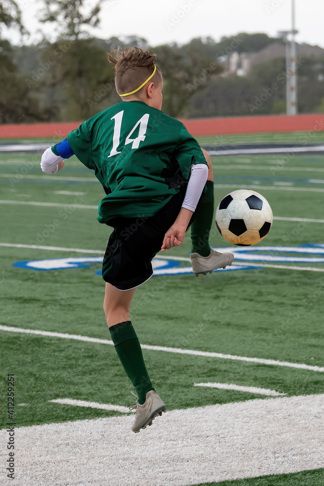 Athletic boy making amazing plays during a soccer game Athletic boy making amazing plays during a soccer game
