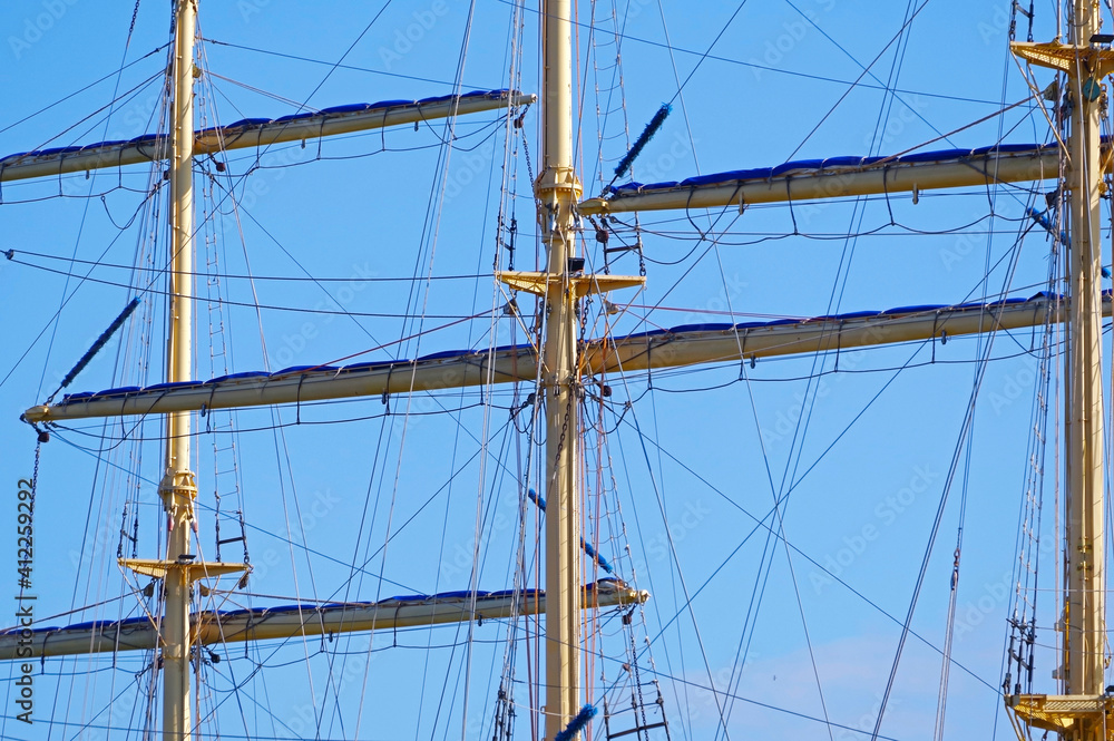 Masts and rigging of a sailing ship against sky Masts and rigging of a sailing ship against sky