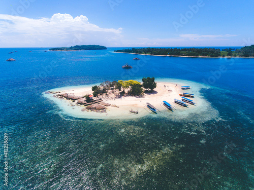 Aerial view of Gili Kedis in Lombok, Indonesia. Beautiful small island with white sandy beach and blue sea water.