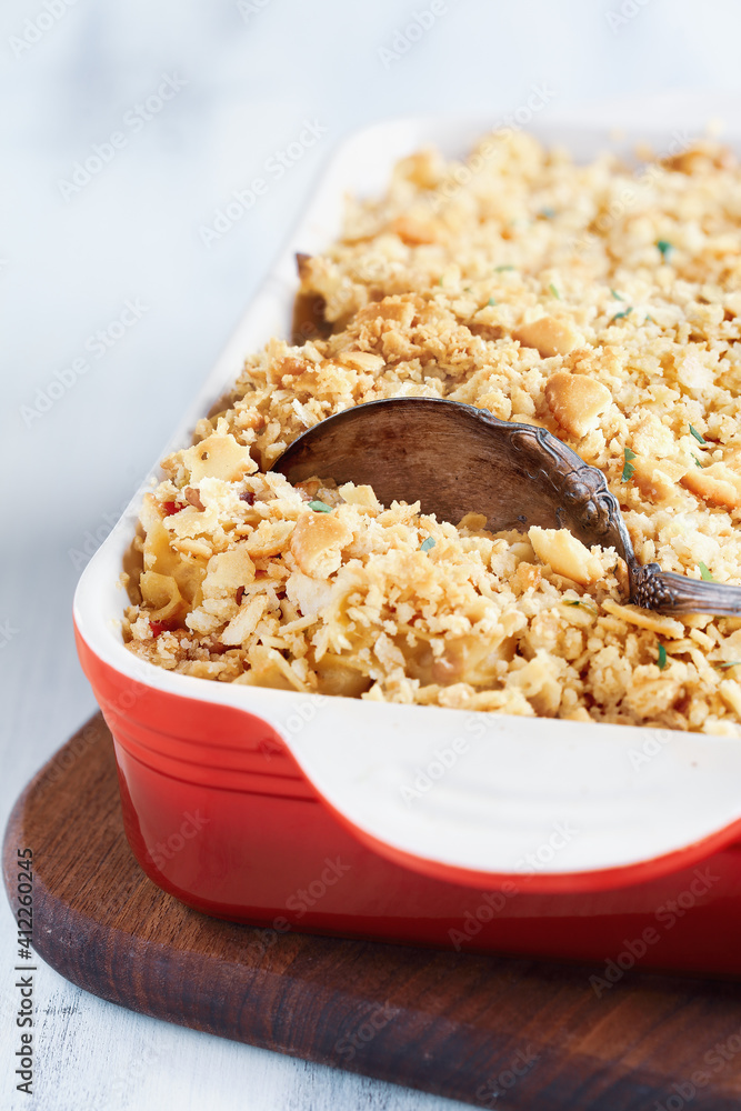 Fresh cheesy tuna casserole with pasta, buttery cracker crumbs and fresh herbs. Could also be used for chicken or ham. Selective focus with blurred background. Fresh cheesy tuna casserole with pasta, buttery cracker crumbs and fresh herbs. Could also be used for chicken or ham. Selective focus with blurred background.