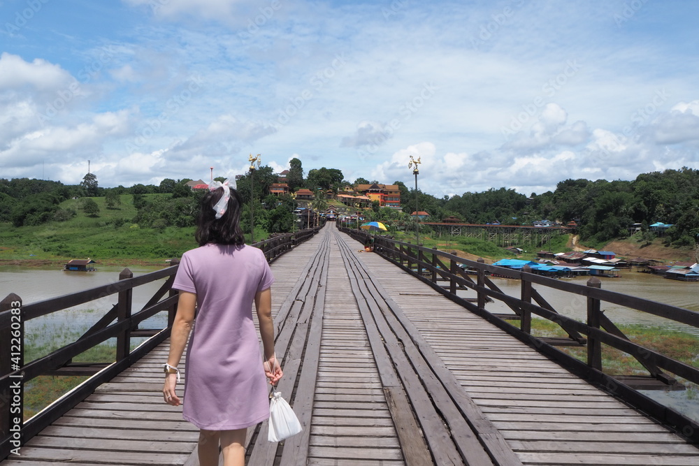 Woman on wooden bridge at Kanchanaburi, Thailand.