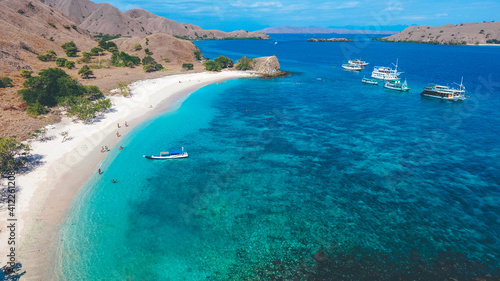 Aerial view of white sand beach in Pink Beach  Labuan Bajo  Indonesia. Sailing boat in Komodo National Park.