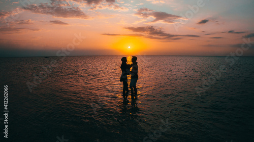 Silhouette of a happy loving couple at sunset on the seashore