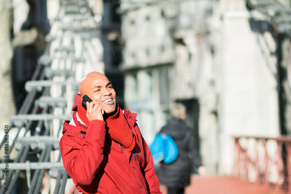Fototapeta premium Concept of business, technology, communication and people - smiling businessman with smart phone talking on city background.