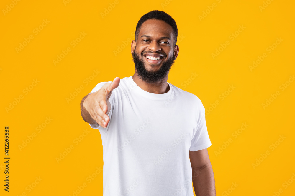Happy African American Man Offering Hand For Handshake, Yellow Background Happy African American Man Offering Hand For Handshake, Yellow Background