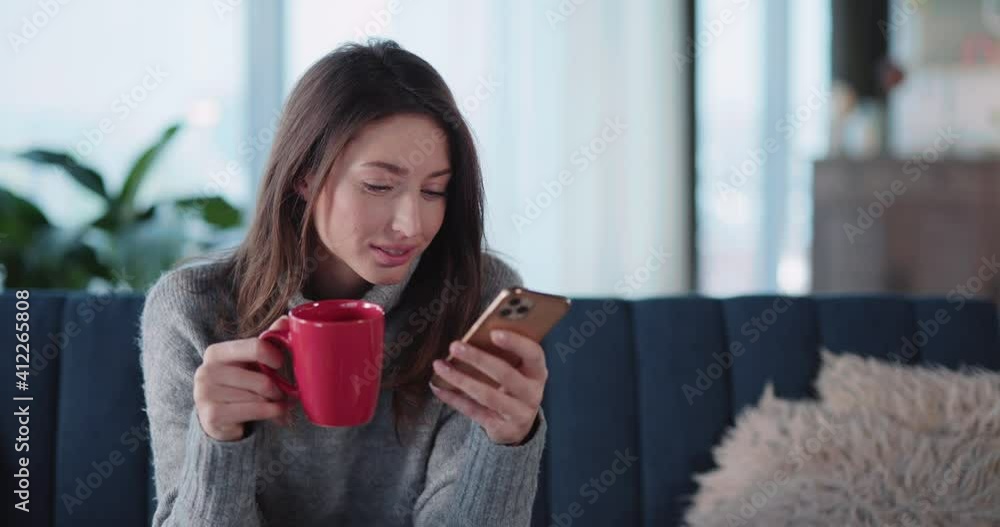 Attractive young modern woman browsing social media notifications staying home drinking coffee in the morning. Hot beverage. Relaxed lifestyle. Attractive young modern woman browsing social media notifications staying home drinking coffee in the morning. Hot beverage. Relaxed lifestyle.