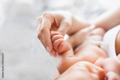 Hand of a newborn baby. Mom holds the baby by the hand. Healthy baby, hospital and happy motherhood concept. Healthy and medical concept. Happy pregnancy and childbirth. Children's theme. 