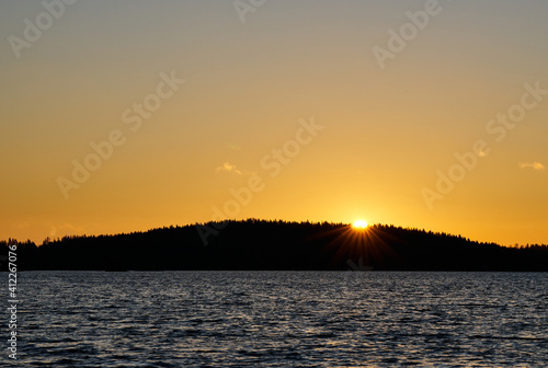 Sun rising behind the forest