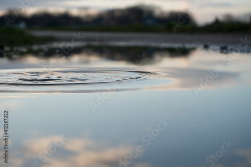 Unruhiges Wasser mit Spiegelung des Himmels  photo