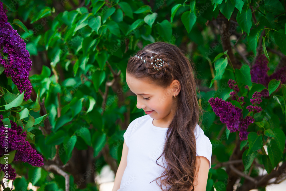 The woman around a blossoming purple lilac in the garden The woman around a blossoming purple lilac in the garden