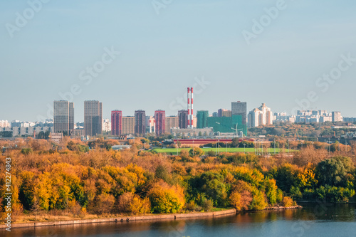 Residential neighborhood in an industrial area on the outskirts of Moscow. Autumn view from the hill to the city in the distance.
