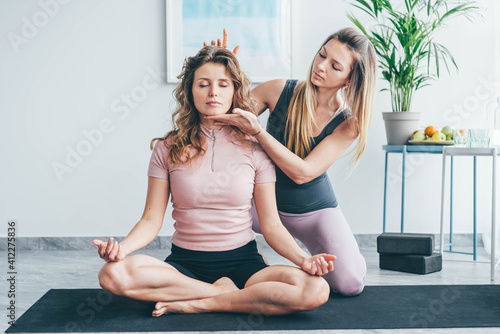 Women doing yoga training together.