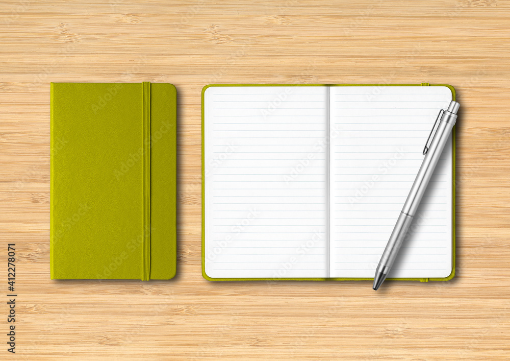 Olive green closed and open lined notebooks with a pen on wooden background Olive green closed and open lined notebooks with a pen on wooden background