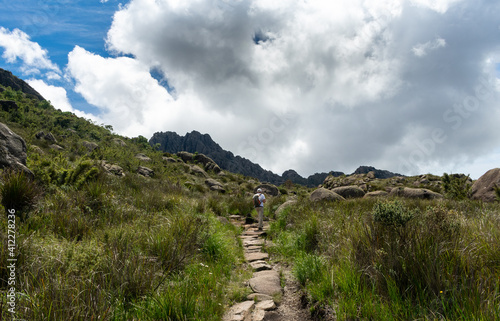 trail at alpine landscape with clouds