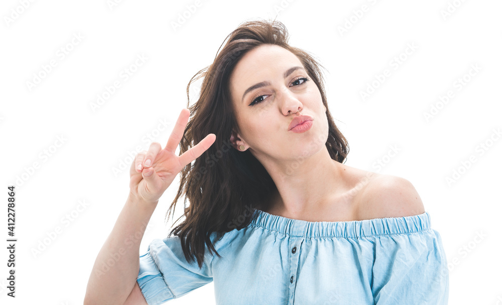 Pretty girl shows peace sing with fingers and send kiss to you, isolated on white background. Joyous lovely woman kissing Pretty girl shows peace sing with fingers and send kiss to you, isolated on white background. Joyous lovely woman kissing